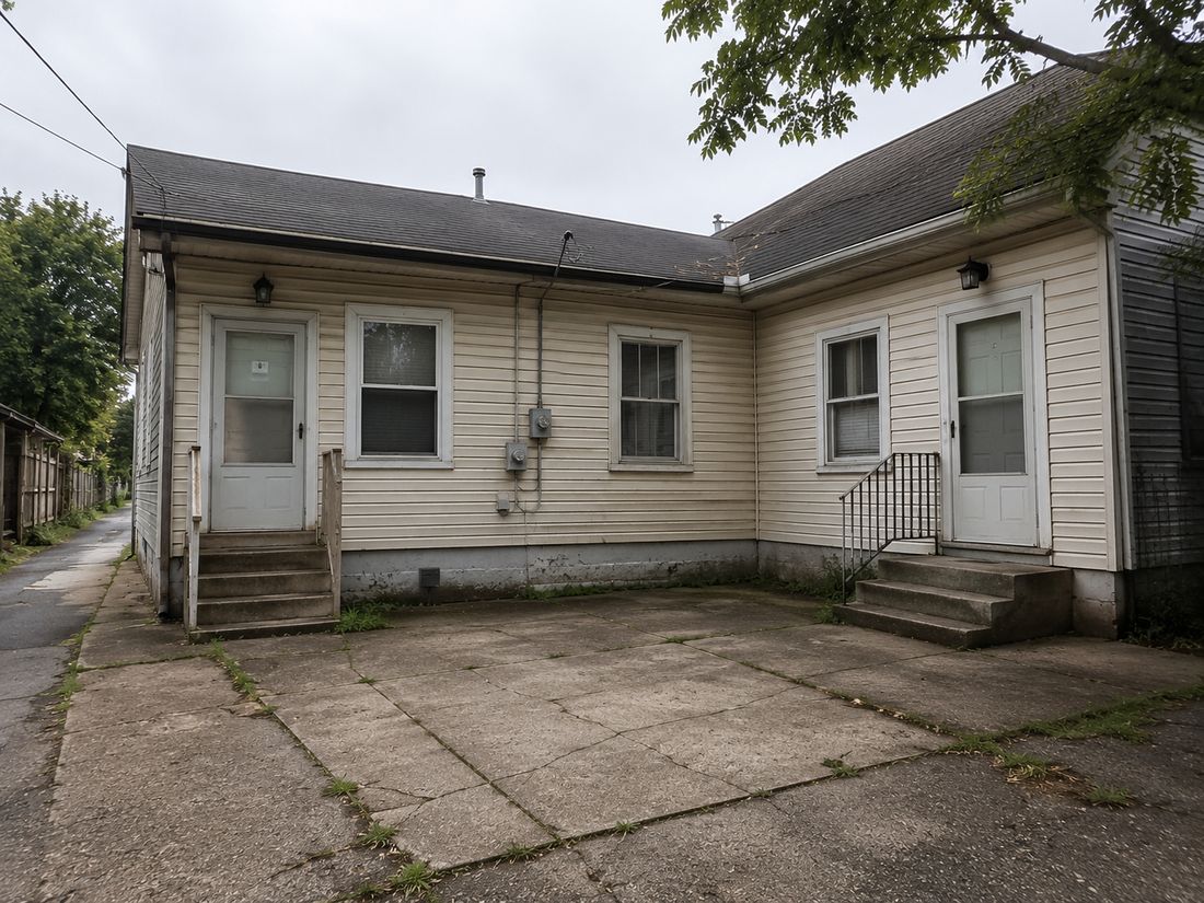 An older home with a concrete patio, bought as-is