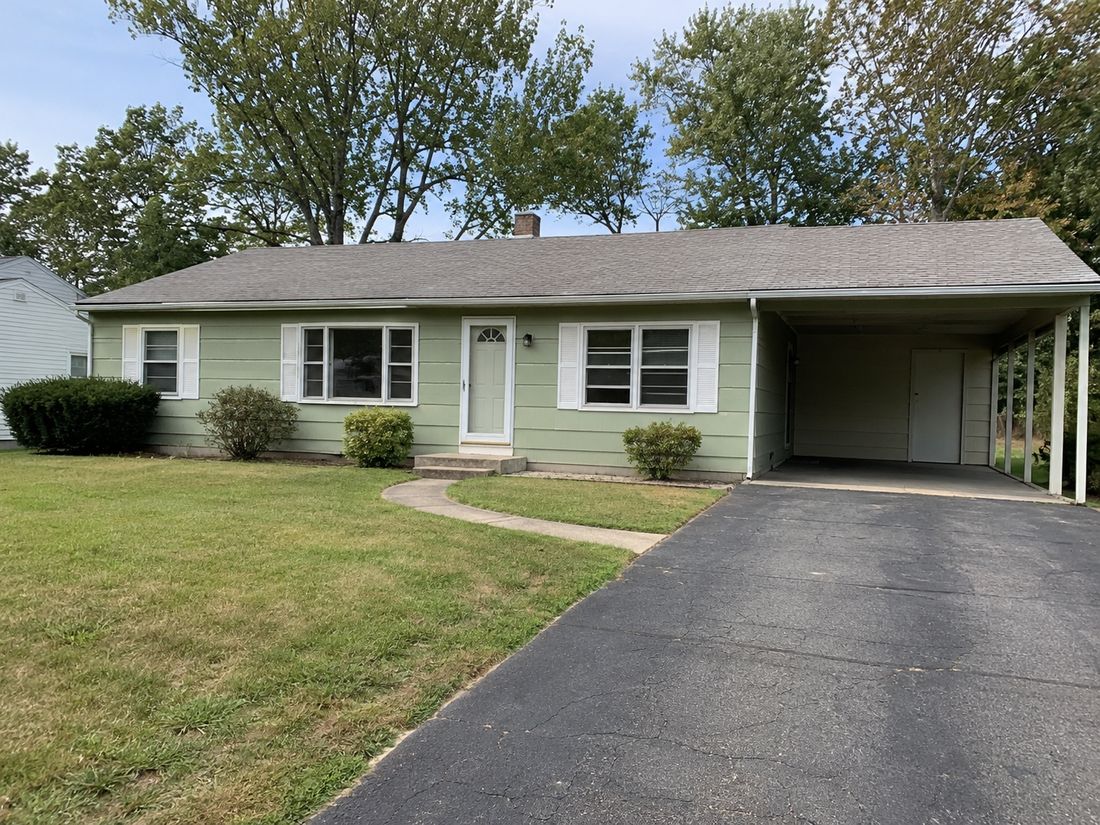 A single-story ranch home with a carport
